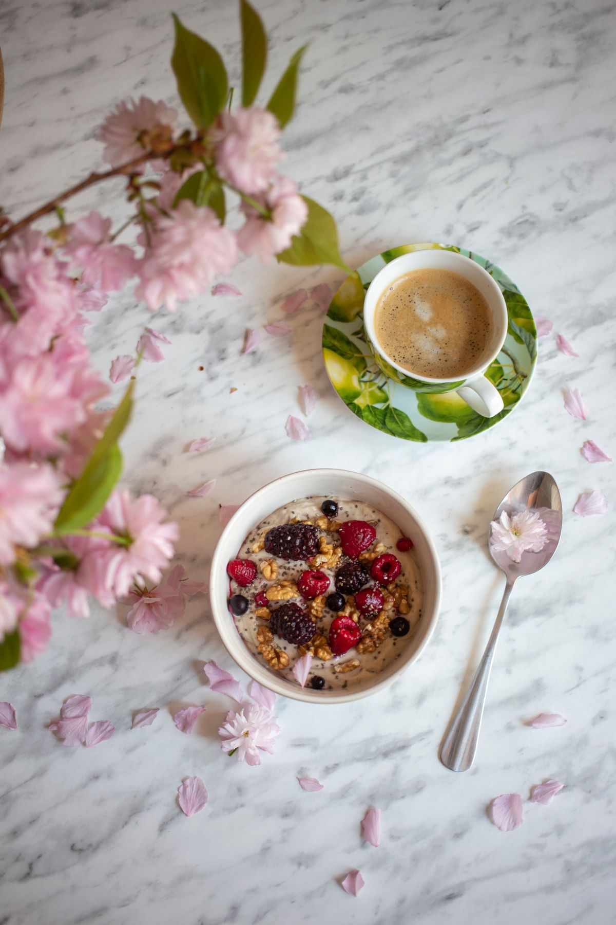 A bowl of berries with a spoon